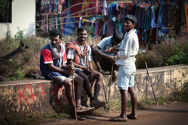 4 Men sat on a wall Anjuna Flea Market Goa