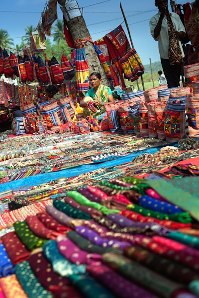 Lady selling sari fabrics, jewelry and bags Anjuna Flea Market Goa