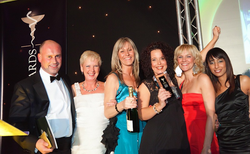 Ladies on a stage with rowlands excellence awards