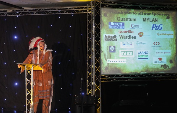 man in red indian costume stood on stage at conference