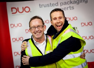 Max Rushden Soccer AM and Dave Billington Duo UK max bear hugging dave in front of duo branding