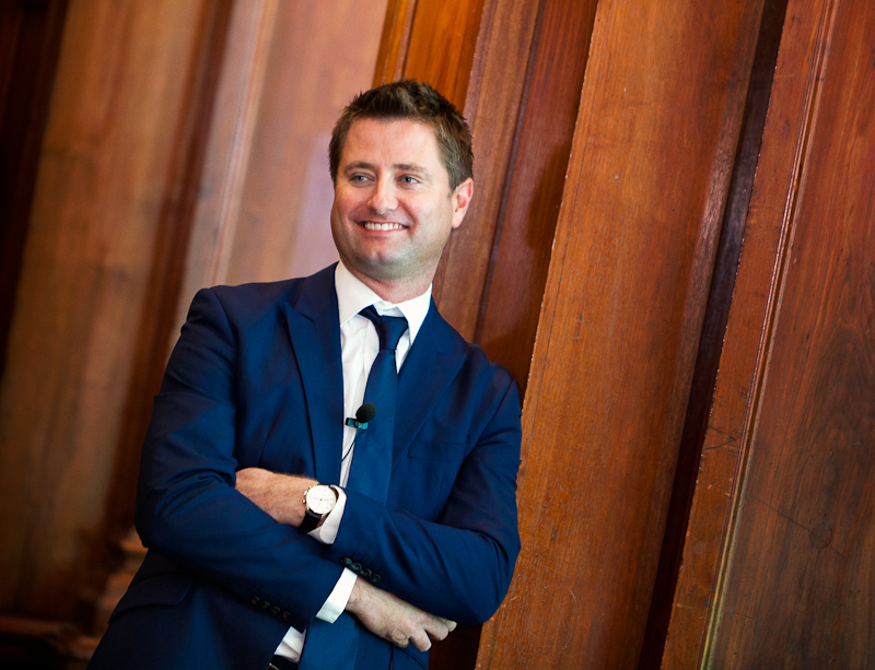 professional portrait of george clarke smiling in a suit
