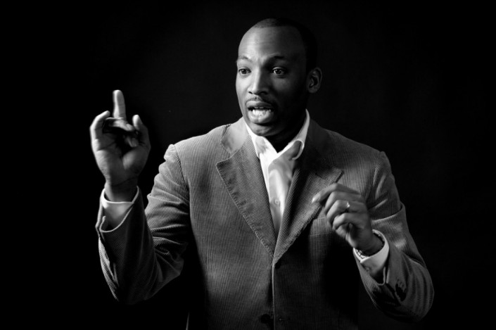 Black man public speaking in black and white