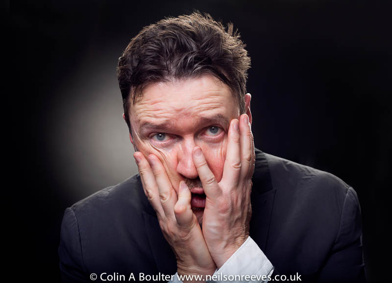 Portrait featuring Ian pulestion-davies with hands on face in a pained expression