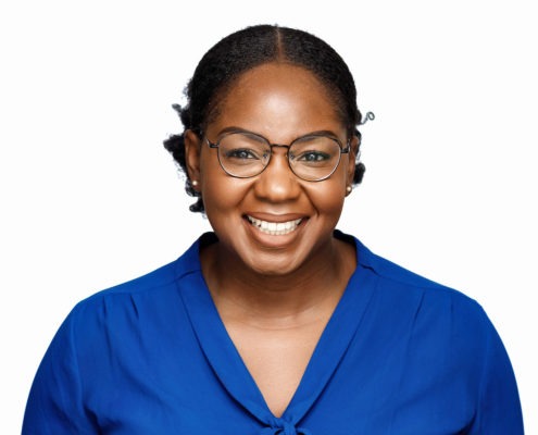 black woman wearing glasses lovely warm smile - electric blue blouse and pure white background