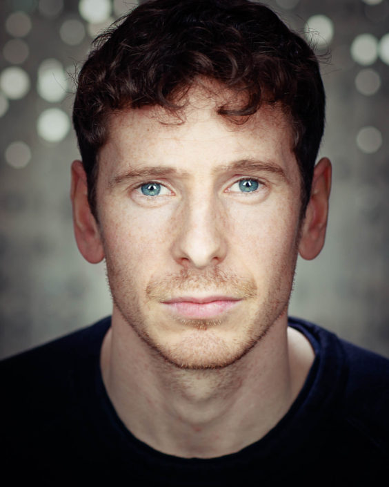 actor headshot featuring actor Gerard Kearns with sparkly grey background