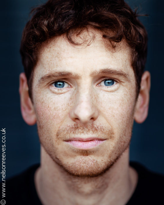 close crop actor headshot featuring actor Gerard kearns with freckles and stunning blue eyes