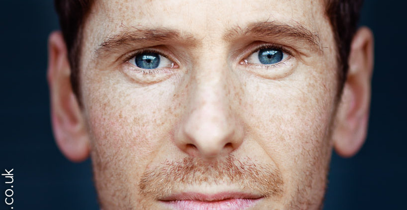 close crop actor headshot featuring actor Gerard kearns with freckles and stunning blue eyes