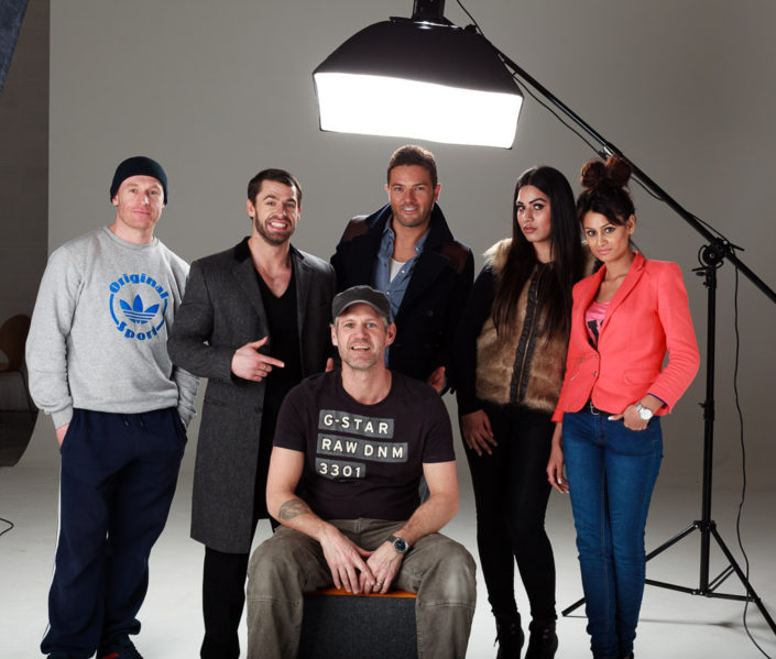 Behind scenes group shot features actor Darren Connolly, Kelvin Fletcher, Colin Boulter in the studio after a shoot. photographed against a black background with studio light in shot