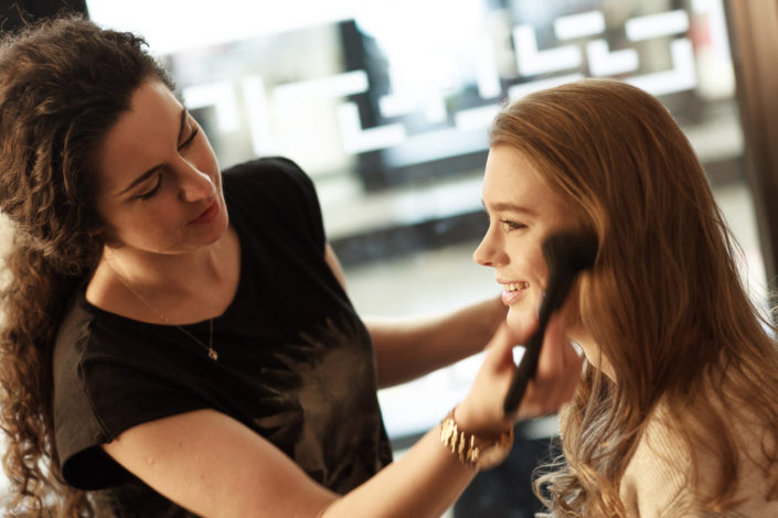 Rebecca Tupman applying makeup to actor Amy-James-Kelly