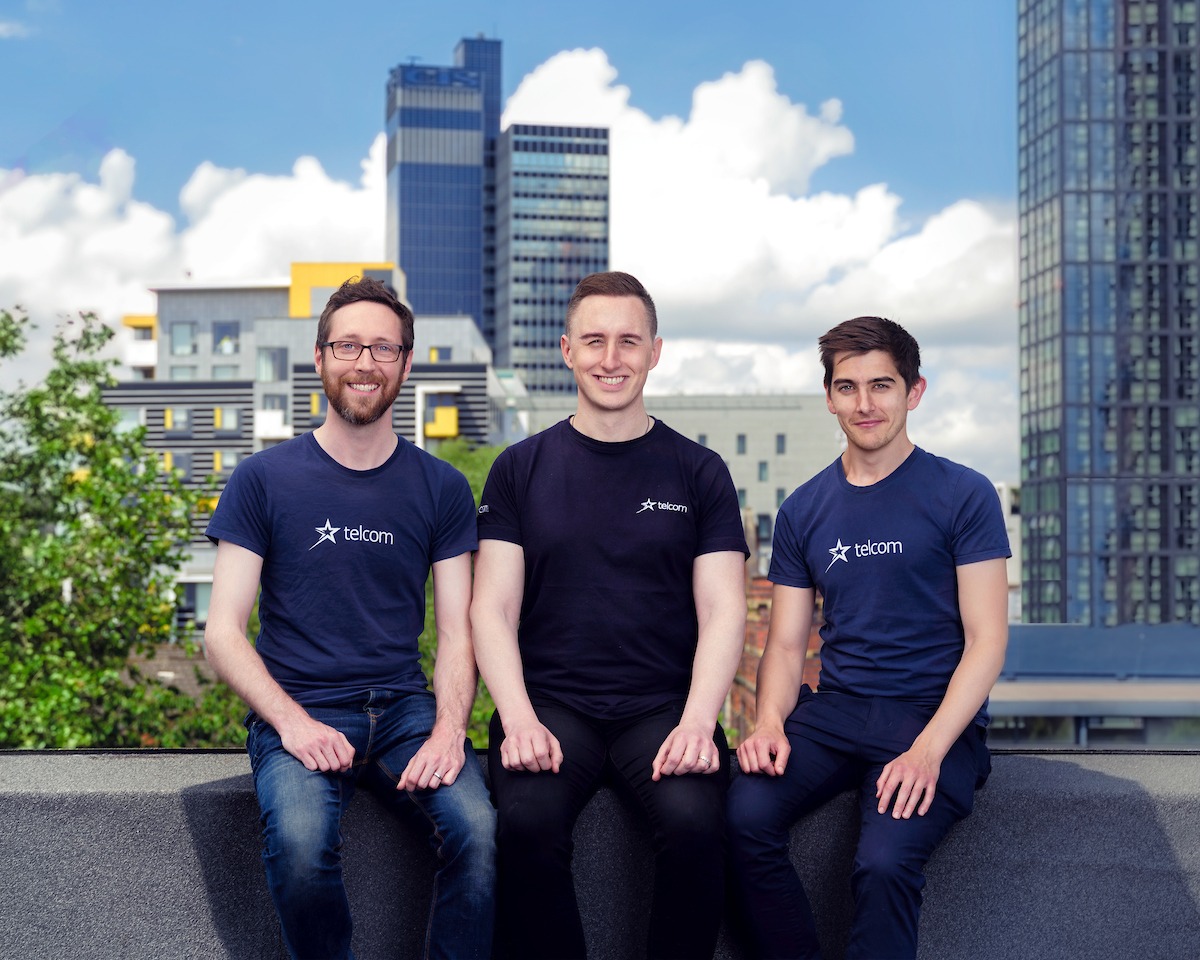 Telcom Founders group shot roof top Manchester CIS behind