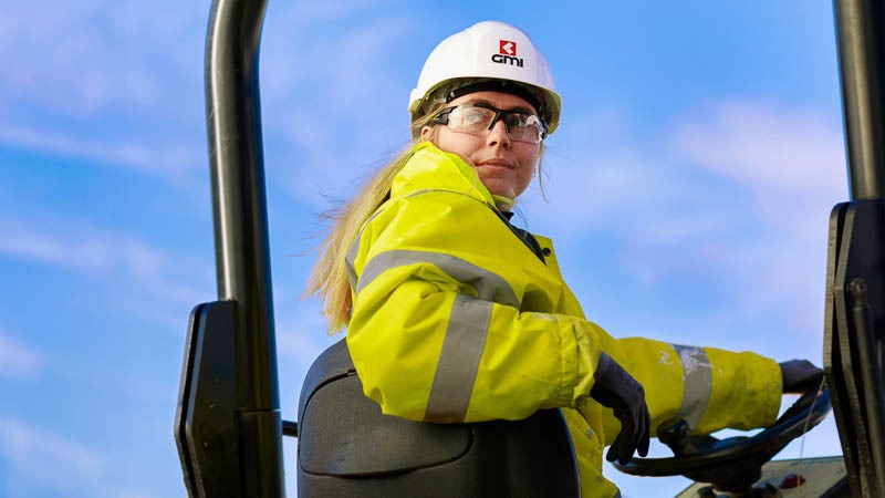 Female site manager reversing a dumper truck 